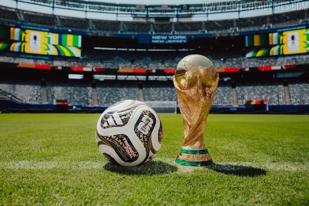 FIFA world cup trophy and football on stadium turf