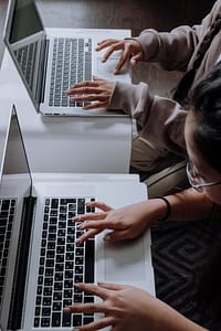 People typing on laptops
