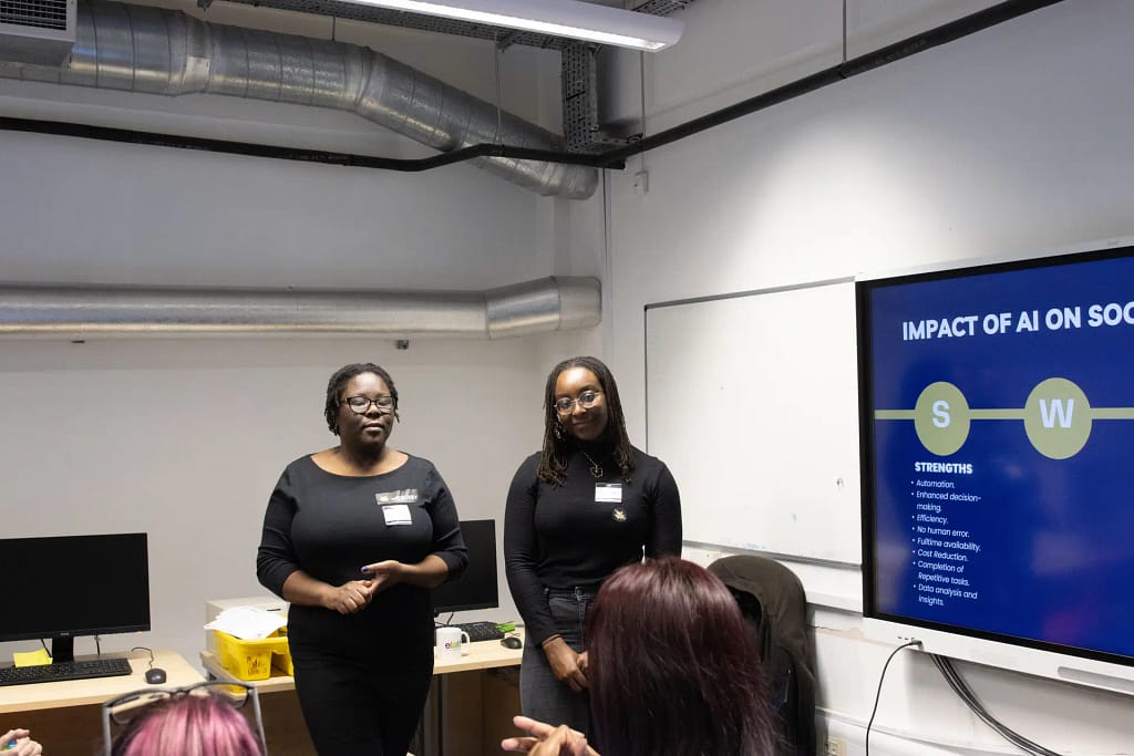Founder Nkeiruka Whenu and Outreach Manager Rachael Olumuyiwa discuss the impact of Artificial Intelligence on society with students