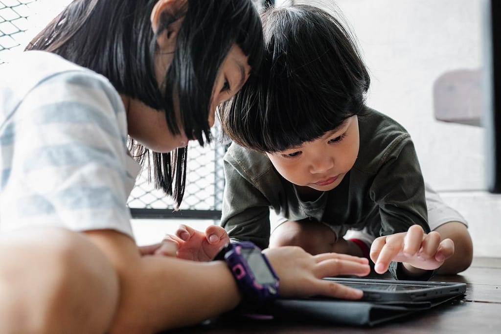 Two kids using ipad