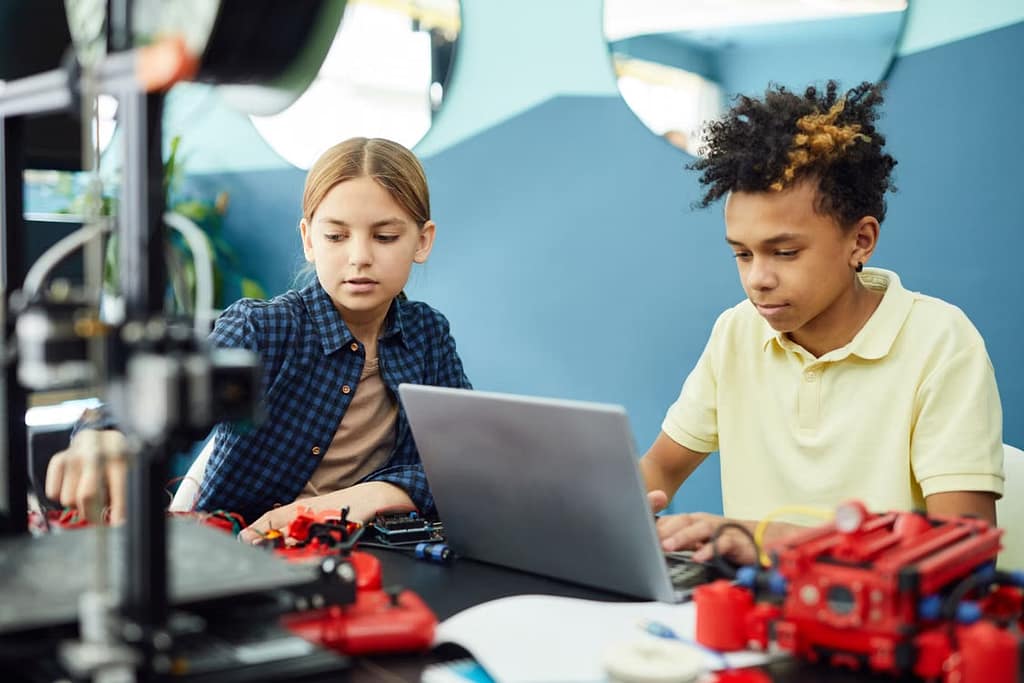 Two kids creating using technology
