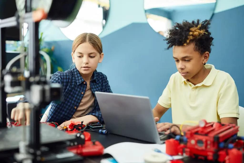 Two kids creating using technology