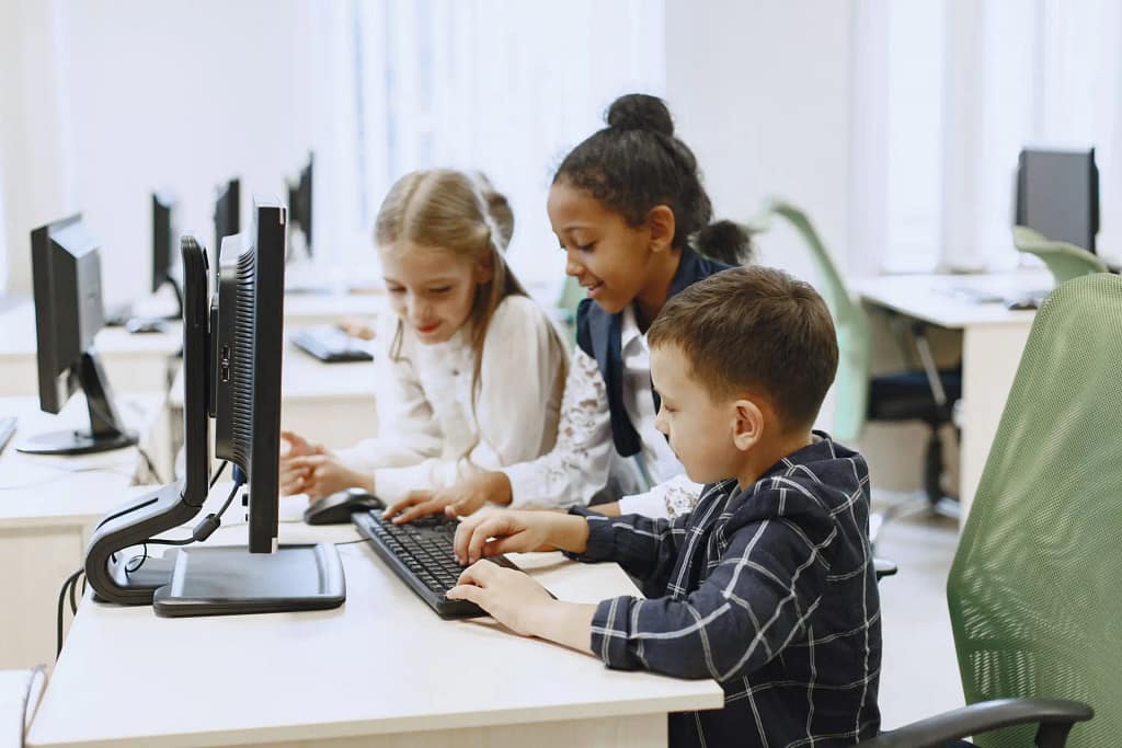 3 kids using a keyboard and computer, Digital Skills