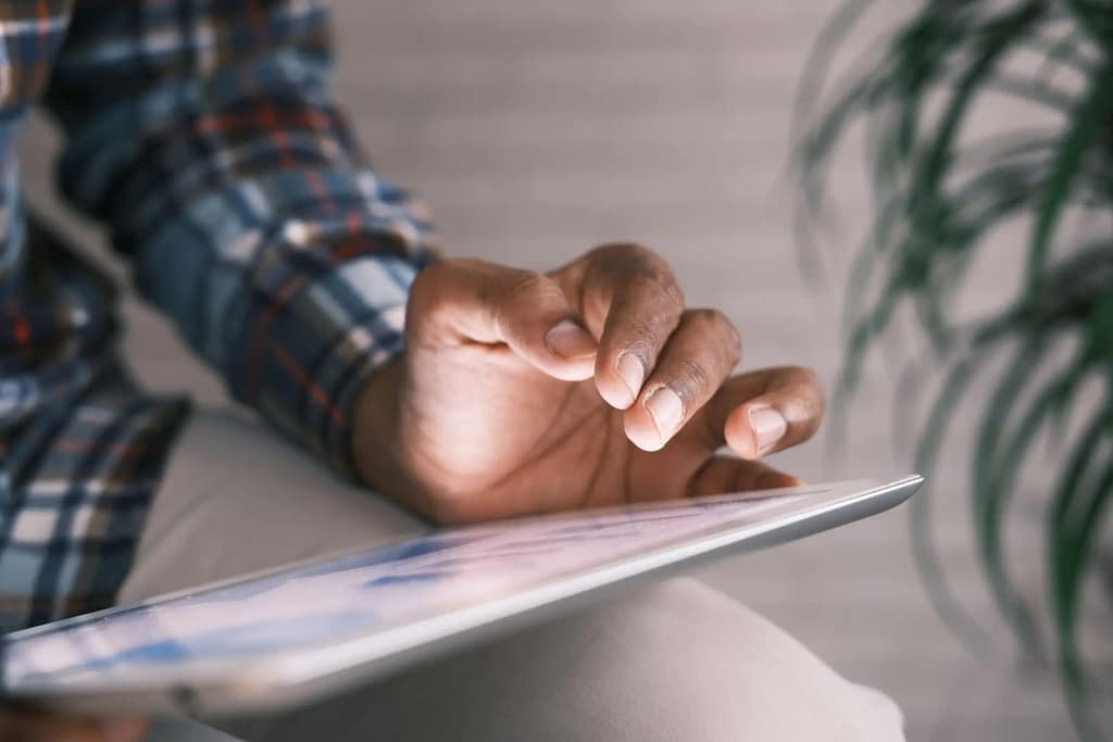 hand hovering over tablet/ipad
