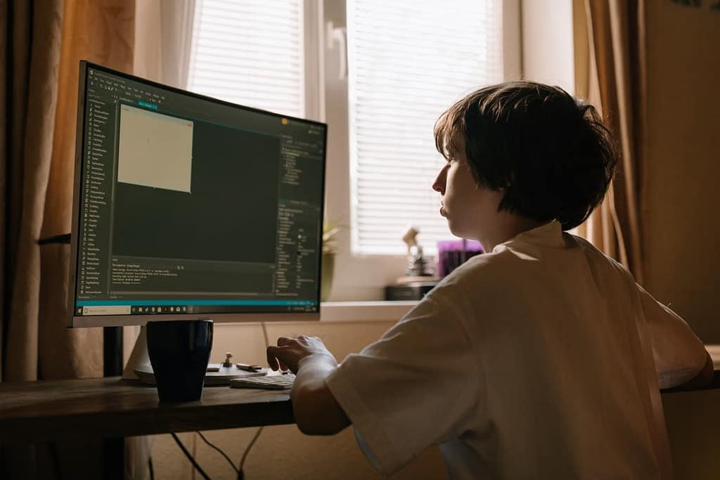 Kid working on computer coding