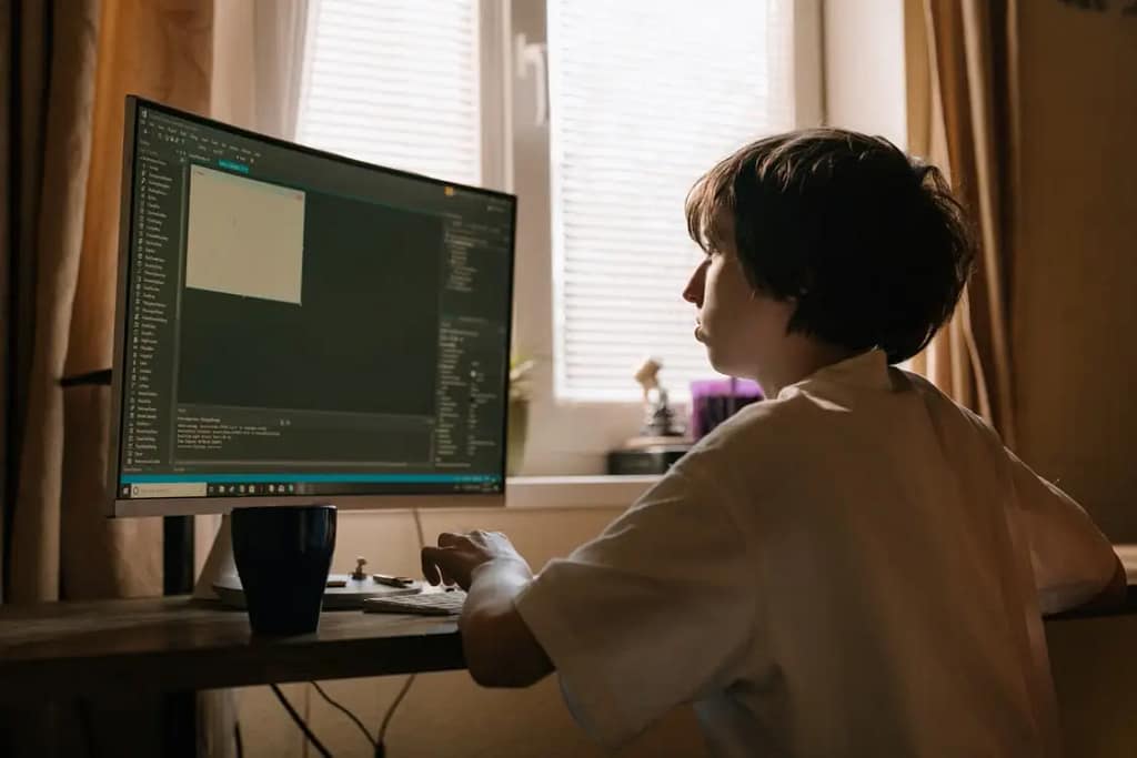 Kid working on computer coding