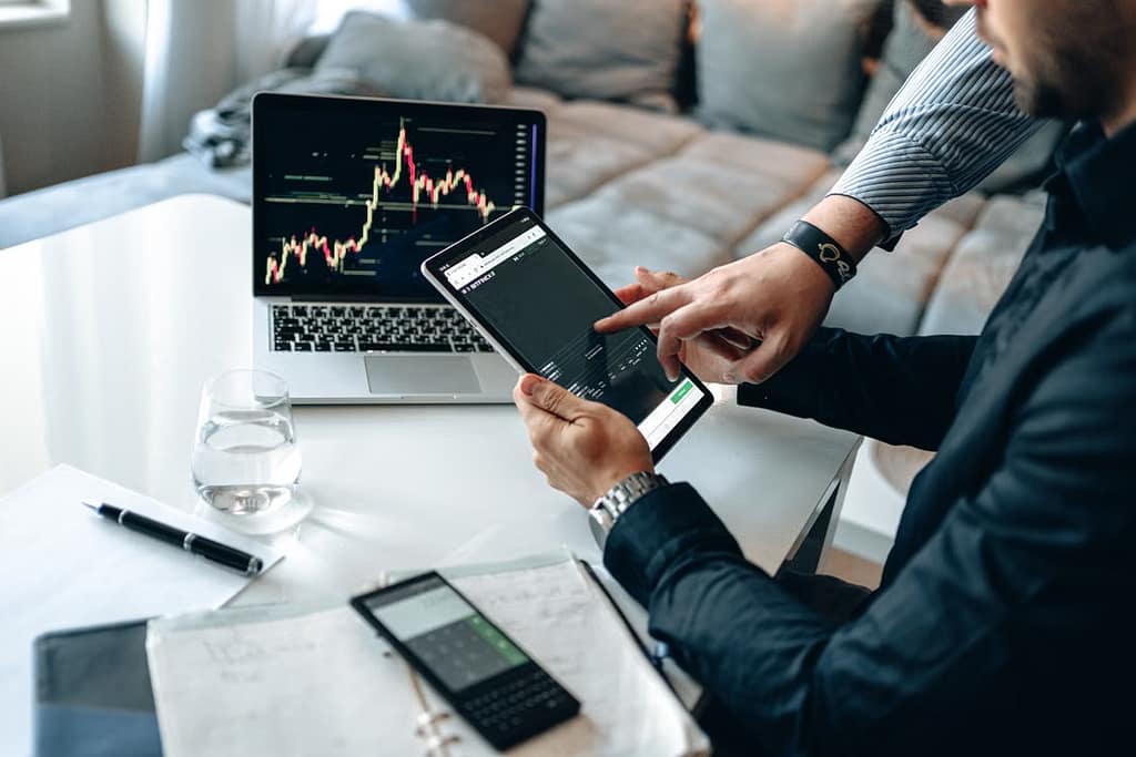 Man pointing to tablet stocks. startups