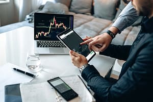 Man pointing to tablet stocks. startups