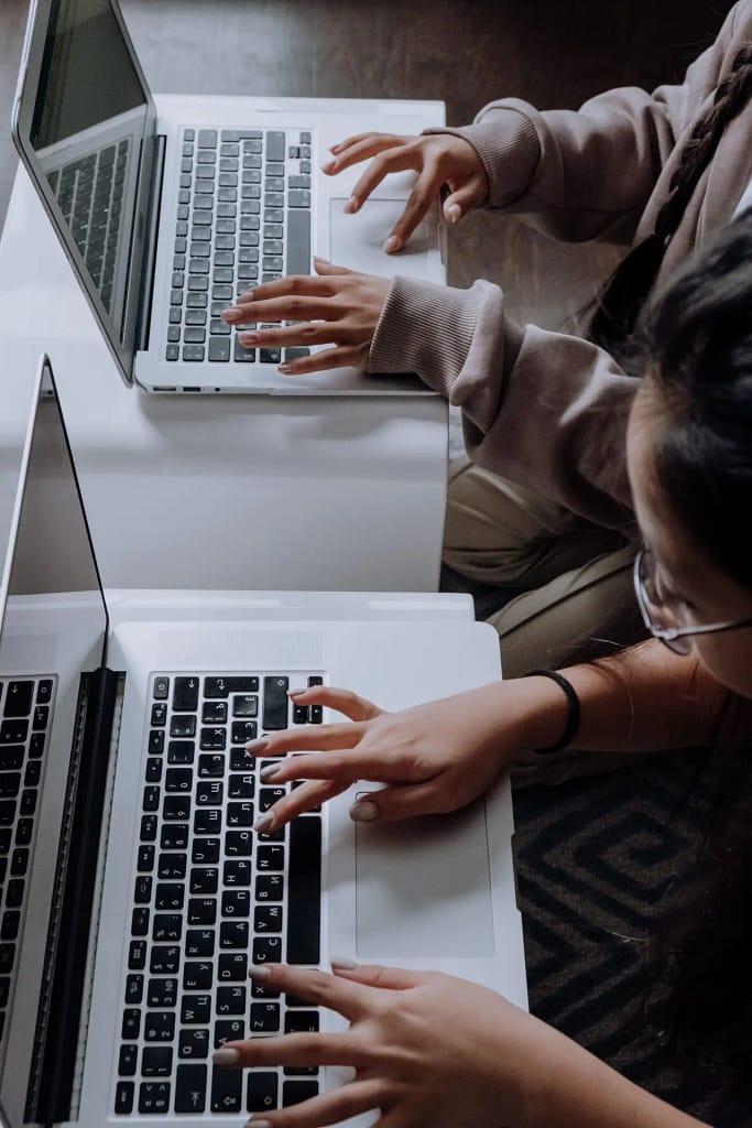 Two girls typing on laptops, Digital Skills