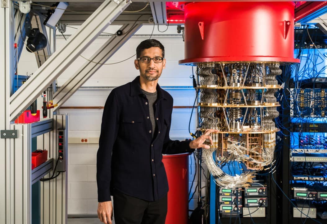 Google’s CEO Sundar Pichai beside a prototype of their Quantum Computer